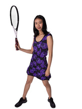 Load image into Gallery viewer, The Monroe Dress has capped sleeves, and moon-shaped ruching in the waistline to accentuate your curves. This print is very limited, the Purple Pansy, with a flattering scoop neckline. Glide around in your Court To Cocktail Tennis dress. Handmade in Los Angeles.