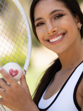 Load image into Gallery viewer, The cutest tennis balls ever. The pressured white balls are handmade in Bath, England (where Adeline the designer was actually born) - and bear the LOVE LOVE TENNIS trademark Heart + Rackets Logo.