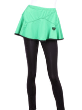 Load image into Gallery viewer, This is our limited edition Triangle Green Skirt with Black Leggings. This piece has a silky soft and quick-drying and binding to match. We make these in very small quantities - by design. Unique. Luxurious. Comfortable. Cool. Fun.