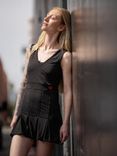 Load image into Gallery viewer, Short Black Angelina Court to Cocktails Tennis Dress. The Angelina Dress is from our sophisticated and elegant collections, for women with a flair for looking good. Our dress is fitted through the bodice, and flares out at the skirt. It is perfect for tennis, running and golf, and of course, a trip to your after-court party with your friends. It was designed for confident women like you! Wear this stunning piece straight from the court to cocktails.