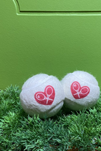 Load image into Gallery viewer, The cutest tennis balls ever. The pressured white balls are handmade in Bath, England (where Adeline the designer was actually born) - and bear the LOVE LOVE TENNIS trademark Heart + Rackets Logo.