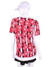 Load image into Gallery viewer, Red Hearts + Stripes Baggy Vee Tee The very comfortable Baggy Vee Tee is so cool and easy to wear. For the lady that likes a little room when she plays - the feminine top is flowing in the air. This Red Hearts + Stripes on white background has a white stripe down the sides, hem, collar and cuff.