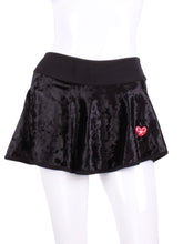 Load image into Gallery viewer, This is our limited edition Crushed Black Velvet LOVE “O” Skirt! Each Skirt is hand cut in ONE PIECE with no side seams! It flows as you twirl on the court. (And we LOVE receiving “slow motion” videos of our clients doing the #tennistwirl on Instagram @ilovemydoublespartner) This piece has a silky soft and quick drying black waistband, shorties and binding to match. We make these in very small quantities - by design. Unique. Luxurious. Comfortable. Cool. Fun.