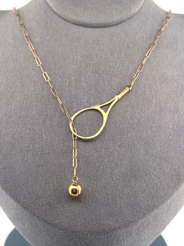 The newest design by Adeline - this unusual necklace is a tennis lovers delight.   The solid gold ball threads through the racket and can be worn higher or lower on the neck.  This piece was hand made in the jewelry district of Los Angeles by a fine jewel craft team.  The racket is 1.5