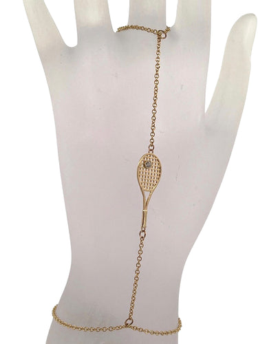 A unique and sexy solid gold racket and diamond ball hand jewel. A dainty chain, solid gold racket, and diamond tennis ball makes this piece special.   14k gold, made by fine artisans in Los Angeles.   Show your love for the sport, on and off the court.