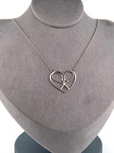 Load image into Gallery viewer, For the true tennis lover - a custom made heart with joint rackets - the logo of the Love Love Tennis brand.  This necklace is made in downtown Los Angeles and the exclusive design by Adeline - and a commitment to the love of tennis.  Each piece is hand cast in solid 14k gold, polished and sent with love.
