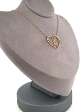 Load and play video in Gallery viewer, For the true tennis lover - a custom made heart with joint rackets - the logo of the Love Love Tennis brand.  This necklace is made in downtown Los Angeles and the exclusive design by Adeline - and a commitment to the love of tennis.  Each piece is hand cast in solid 14k gold, polished and sent with love.
