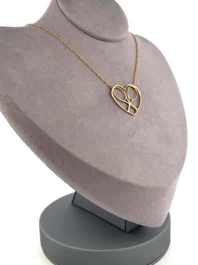 For the true tennis lover - a custom made heart with joint rackets - the logo of the Love Love Tennis brand.  This necklace is made in downtown Los Angeles and the exclusive design by Adeline - and a commitment to the love of tennis.  Each piece is hand cast in solid 14k gold, polished and sent with love.