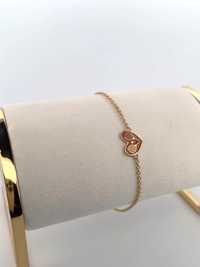 This 14k solid gold pink heart and pickleball bracelet was designed by Adeline and made in downtown Los Angeles.    A luxurious forever piece of jewelry.  Carefully crafted with a barrel clasp and safety piece - so that you can play/shower AND party in it!  The heart measures 0.5” and the chain is 6” total.