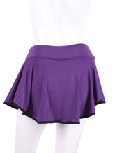 Load image into Gallery viewer, This limited Purple LOVE &quot;O&quot; Skirt has shorties underneath and NO seams on the &quot;O&quot;!  It&#39;s cut like a doughnut to show and move beautifully as you play.  The fabric is uber soft and light - it dries quickly - and protects from UV rays too.  This skirt has a “nearly naked” feel about it.  The embroidery Heart is Black + Rackets and Ball Purple to match the skirt.  Sleek black thread and binding.

