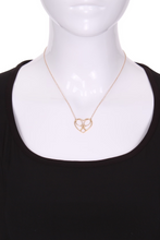 Load image into Gallery viewer, For the true tennis lover - a custom made heart with joint rackets - the logo of the Love Love Tennis brand.  This necklace is made in downtown Los Angeles and the exclusive design by Adeline - and a commitment to the love of tennis.  Each piece is hand cast in solid 14k gold, polished and sent with love.
